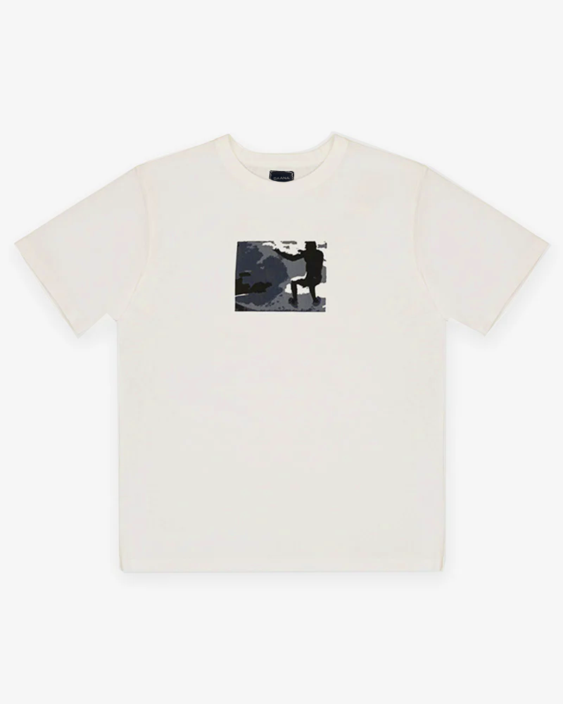 A faded white t-shirt with a screen print of a person surfing.